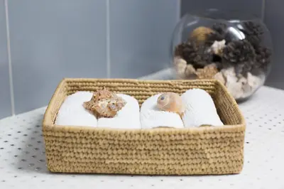 a basket with towels and a snail on it on a table at Acropolis Now! 2BR in central Athens in Athens