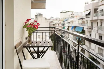a balcony with a vase of flowers on a table at Acropolis Now! 2BR in central Athens in Athens