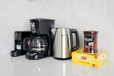 a counter top with a coffee maker and a coffee pot at Poseidon Residence in Athens
