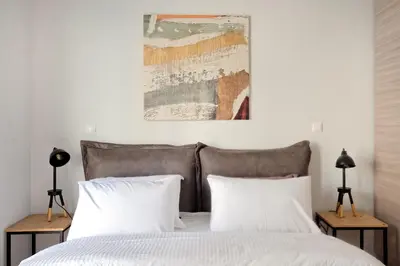 a bedroom with a bed with two pillows at Poseidon Residence in Athens