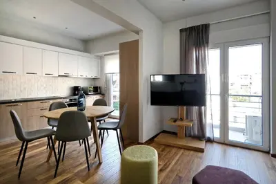a kitchen and dining room with a table and chairs at Poseidon Residence in Athens