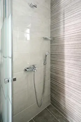 a shower with a hose in a bathroom at Poseidon Residence in Athens