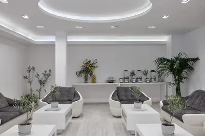 a living room with couches and potted plants at Boss Boutique Athens by Prima Hotels in Athens