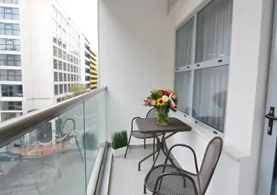 a balcony with a table and chairs and a vase of flowers at Boss Boutique Athens by Prima Hotels in Athens