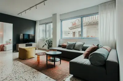 a living room with a couch and a tv at Stylish Suite, by MGM Residencies in Athens