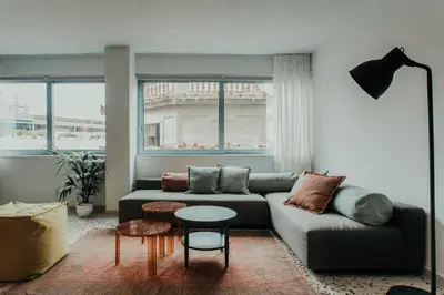 a living room with a couch and a table at Stylish Suite, by MGM Residencies in Athens