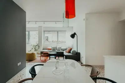 a living room with a table and a couch at Stylish Suite, by MGM Residencies in Athens