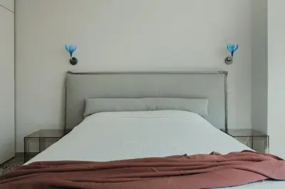 a bedroom with a bed with two glass tables at Stylish Suite, by MGM Residencies in Athens