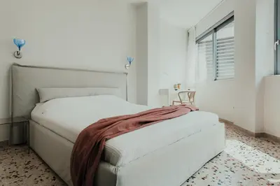 a white bedroom with a bed with a blanket on it at Stylish Suite, by MGM Residencies in Athens