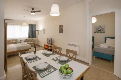 a kitchen and living room with a table and chairs at Central apartment on pedestrian street by GHH in Athens