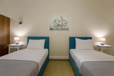 two beds in a room with two lamps on tables at Central apartment on pedestrian street by GHH in Athens