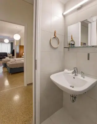 a bathroom with a sink and a mirror at Central apartment on pedestrian street by GHH in Athens