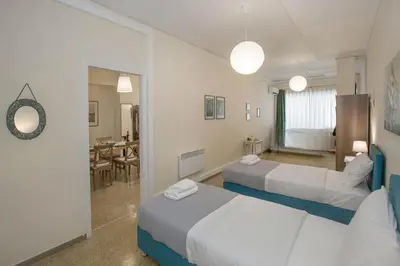 a hotel room with two beds and a dining room at Central apartment on pedestrian street by GHH in Athens