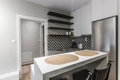 a kitchen with a white counter top and a refrigerator at ATHENSIS Apartments in Central Athens in Athens