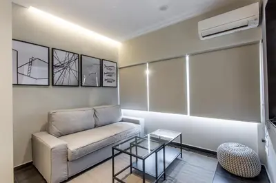 a living room with a couch and a table at ATHENSIS Apartments in Central Athens in Athens