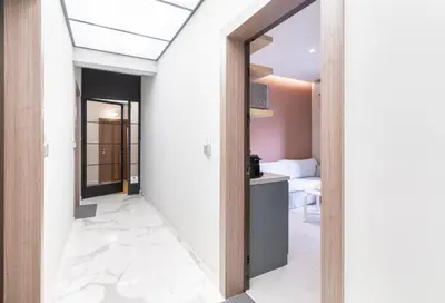 a hallway with white walls and a ceiling with a skylight at ATHENSIS Apartments in Central Athens in Athens