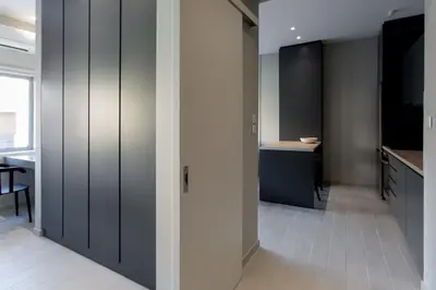 a hallway with grey cabinets and a desk in a room at ATHENSIS Apartments in Central Athens in Athens