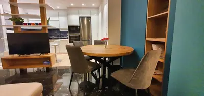 a kitchen with a table with chairs and a television at The Six Museums central Athens Stadium 4pers apart in Athens
