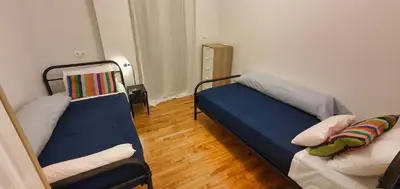 a small room with two beds and a couch at The Six Museums central Athens Stadium 4pers apart in Athens