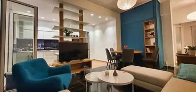a living room with a couch and a tv at The Six Museums central Athens Stadium 4pers apart in Athens