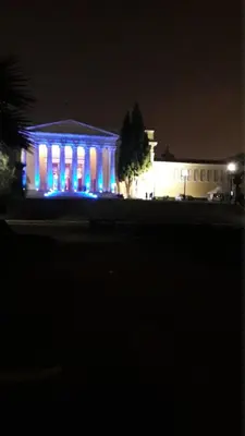 a building with blue lights in front of it at night at The Six Museums central Athens Stadium 4pers apart in Athens