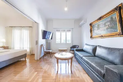 a living room with a couch and a table at Victoria Supreme Suite in Athens