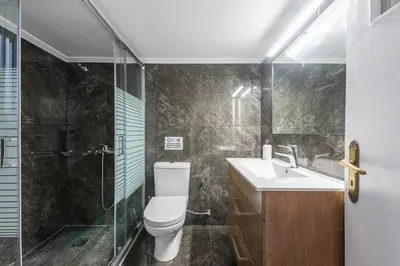 a bathroom with a toilet and a shower and a sink at Victoria Supreme Suite in Athens