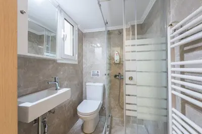 a bathroom with a toilet and a sink and a shower at Victoria Supreme Suite in Athens