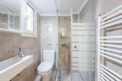 a bathroom with a toilet and a shower at Victoria Supreme Suite in Athens