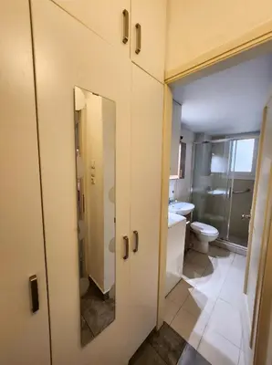 a bathroom with a toilet and a sink and a mirror at Lycabettus Edge in Athens