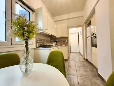 a vase of flowers on a table in a kitchen at Lycabettus Edge in Athens