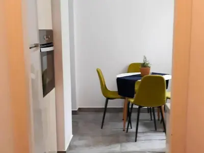 a dining room with a table and yellow chairs at Lycabettus Edge in Athens
