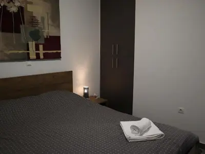 a bedroom with a bed with a towel on it at Nefeli in Athens