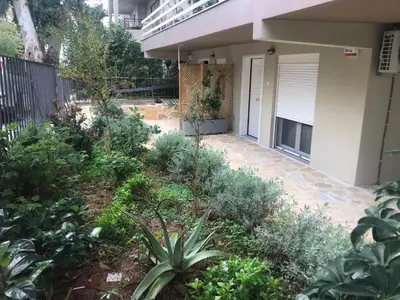 a garden in front of a house with plants at Nefeli in Athens