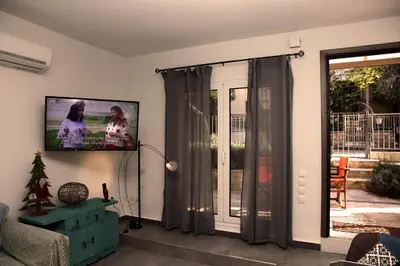 a living room with a flat screen tv on the wall at Nefeli in Athens