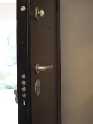 a wooden door with a metal handle on it at Nefeli in Athens