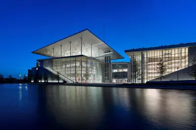 a large building with a lot of windows at night at Nefeli in Athens