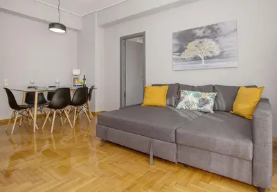 a living room with a gray couch and a table at Cozy apartment in Syntagma-Plaka by GHH in Athens