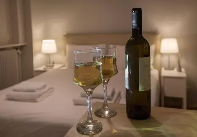 a bottle of wine and two glasses on a table at Cozy apartment in Syntagma-Plaka by GHH in Athens