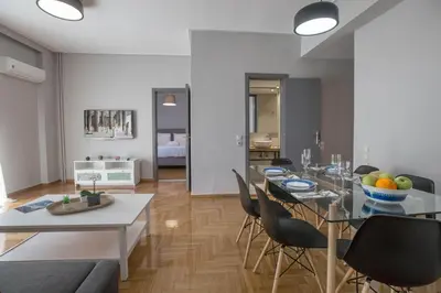 a dining room and living room with a table and chairs at Cozy apartment in Syntagma-Plaka by GHH in Athens