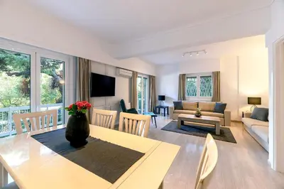 a living room with a dining table and a living room at Boutique77 Luxury Apartment in Athens