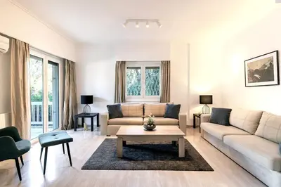 a living room with a couch and a table at Boutique77 Luxury Apartment in Athens