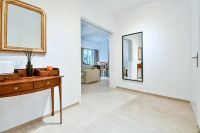a living room with a table and a mirror at Boutique77 Luxury Apartment in Athens