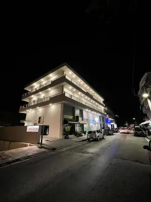 a building on the side of a street at night at Aethon Airport Project-FREE SHUTTLE by GK Properties in Markopoulo