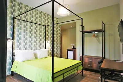 a bedroom with a canopy bed with a yellow bedspread at Aethon Airport Project-FREE SHUTTLE by GK Properties in Markopoulo
