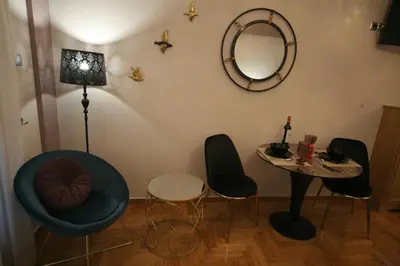 a room with chairs and a table and a mirror at Denise Luxury Apartment-Centre of Athens,Kolonaki in Athens