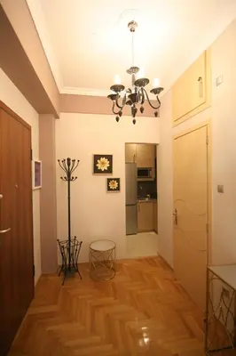 a living room with a chandelier and wooden floors at Denise Luxury Apartment-Centre of Athens,Kolonaki in Athens