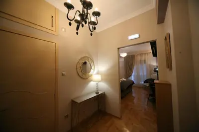 a hallway with a mirror and a chandelier at Denise Luxury Apartment-Centre of Athens,Kolonaki in Athens