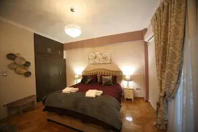 a bedroom with a bed with two towels on it at Denise Luxury Apartment-Centre of Athens,Kolonaki in Athens