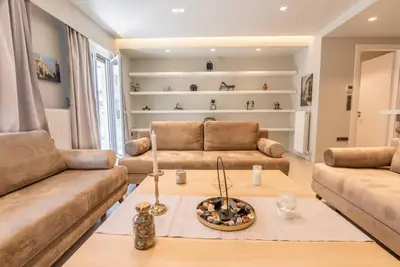a living room with two couches and a table at Luxurious apartment in Acropolis in Athens